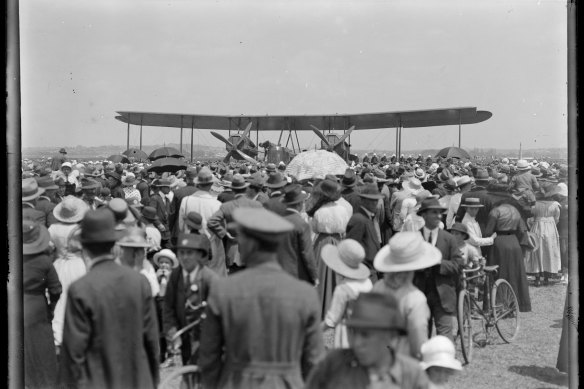 Crowd around the aeroplane: This image shows the Smith brothers arriving at Mascot airport after their record breaking flight in 1920.