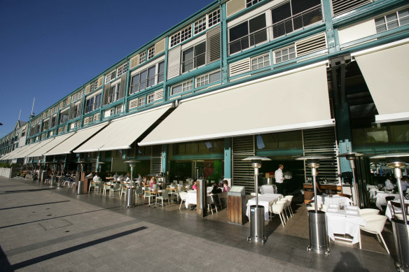 The restaurant strip at the finger wharf buzzes on a sunny autumn day.