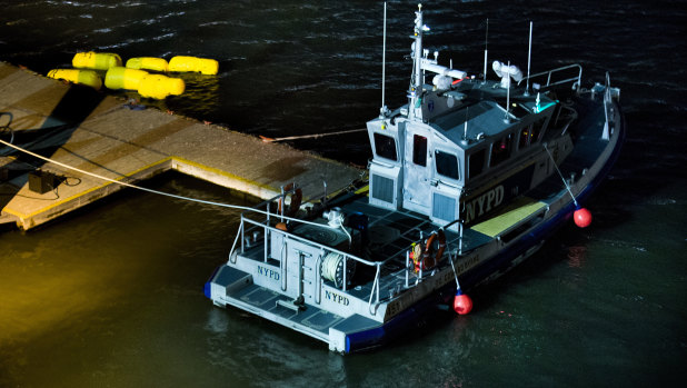Yellow buoys that a New York police officer said are suspending a helicopter that crashed into the East River.