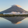 Reflection of Mount Taranaki at sunset. Egmont National Park, North Island, New Zealand. 