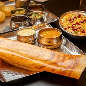 The CTR masala dosa, a rolled pancake with spiced potato filling, and accompaniments.