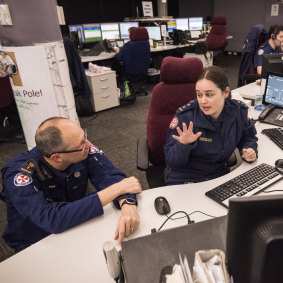 Reverend Paul McFarlane, senior chaplain for NSW Ambulance service, speaks with Rachel Moran, Dispatch Manager for West and Far West Regions at Sydney Control Centre