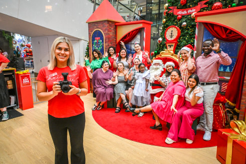 Say cheese: Morihovitis with staff from Annecto aged care and disability support services posing with Santa.