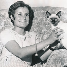 Ainsley Gotto pictured in 1969 with one of her family's Siamese cats.