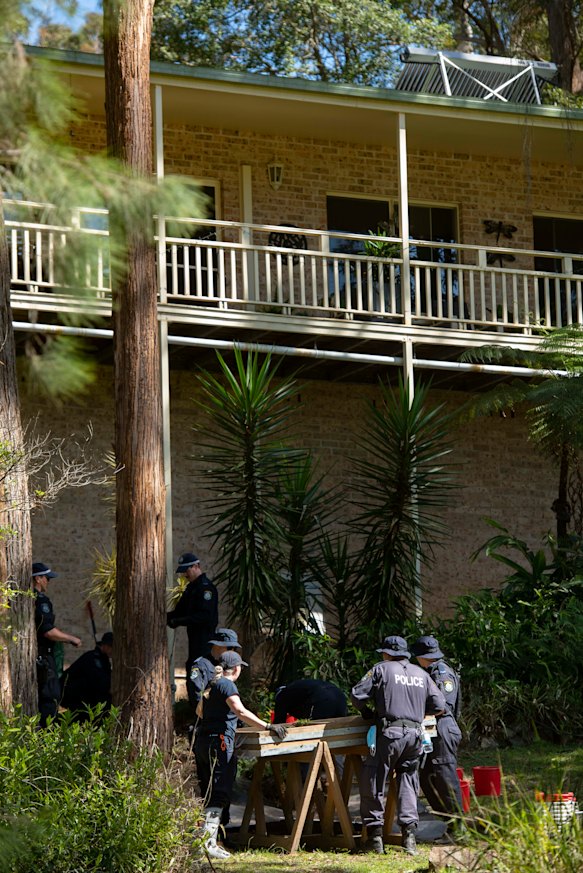 NSW Police search the gardens below a balcony at the home from which William Tyrrell disappeared.