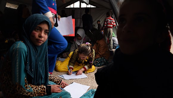 Twelve-year-old Luma (center in a yellow dress) saw her mother beaten and then shot dead in front of her by ISIS. She then carried her 18-month-old sister for 2 hours to safety.