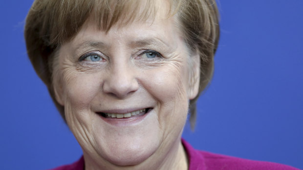 Germany's Social Democrats voted to join Chancellor Angela Merkel's next government, clearing the last hurdle to her fourth term.