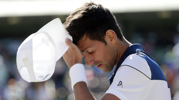 Frustration: Novak Djokovic walks to his chair.