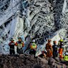 Rescue workers are seen working at the collapsed construction building.