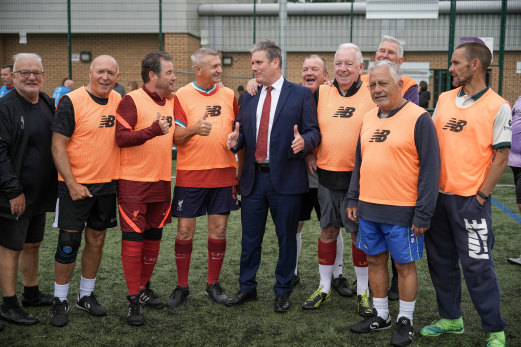 British Labor leader Keir Starmer meets soccer players walking in Liverpool, England, in July.