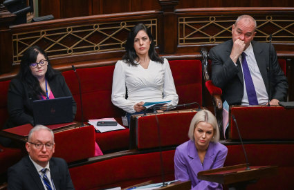 Moira Deeming (in white) sitting on the crossbench in June.