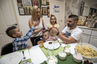 Cracking fun: Paul and Maria Manolis crack eggs with their kids James, Anastasia and Nikolai (centre). 