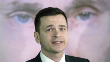 Russian opposition activist Ilya Yashin is overshadowed by a giant portrait of the man who defines all Russian politics.