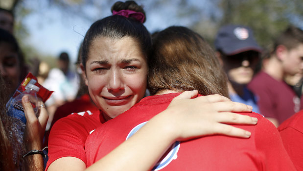 A student mourns the loss of her friend during a community vigil in Parkland, Florida.