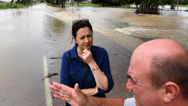 Queensland Premier Annastacia Palaszczuk is briefed by Hinchinbrook Shire Mayor Ramon Jayo as she surveys floods in Ingham.