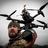A Ukrainian soldier demonstrates a locally-made drone in the Kyiv region.