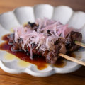 Skewers of wagyu rump cap teriyaki-glazed and topped with pickled shallots.