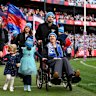 Neale Daniher and his family complete a lap of honour at the MCG before Monday’s Big freeze match between Melbourne (the team he used to coach) and Collingwood.