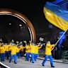 Vladyslav Heraskevych carries the flag for Ukraine in the opening ceremony.