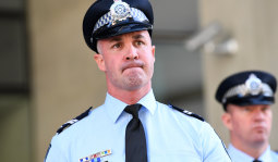 Senior Constable Aaron Izzard speaks to the media outside the District Court in Brisbane on Friday.