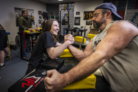 Arm in arm: Celine Van Os arm-wrestles House of Pain president Andrew Lea.