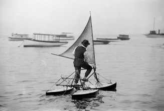A man operates a water tricycle in the early 20th century. 
