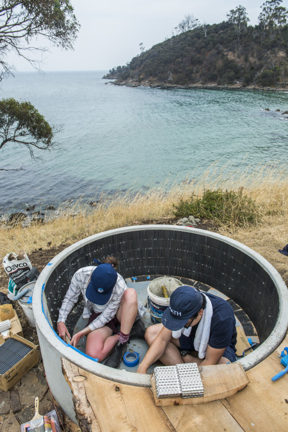 Participants work on the open-air spa, made of concrete and lined with Japanese tiles.