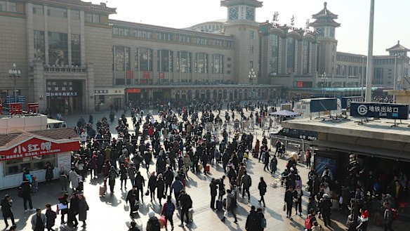 Passengers heading towards check-in at Beijing Railway Station.