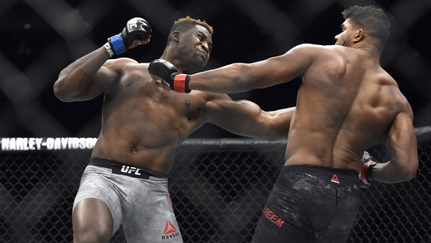 Francis Ngannou (left) hits Alistair Overeem in the first round of their UFC 218 heavyweight bout.