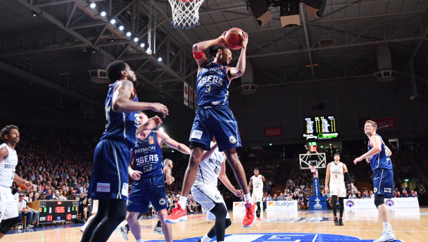 Josh Childress of the 36ers flies high during their win but raised concerns when he crashed to the floor in the final term holding his shoulder.