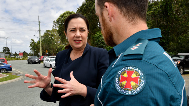 Premier Annastacia Palaszczuk speaking to a paramedic in the new Logan electorate of Macalister on Wednesday.