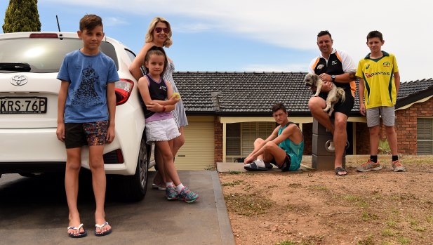The Haywood family in front of their home in Erskine Park: Ryan Haywood 11, Keeley Haywood 8, Kristy Haywood, Lachlan Haywood 15, Cameron Haywood holding Tigah, and Joel Haywood 13. 
