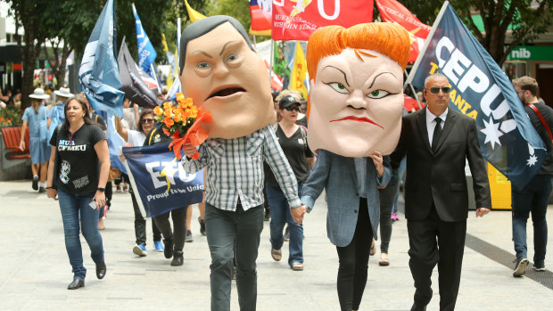 Protestors dressed as caricatures of Tim Nicholls and Pauline Hanson at the Queensland Council of Unions (QCU) march through the Brisbane on Wednesday.