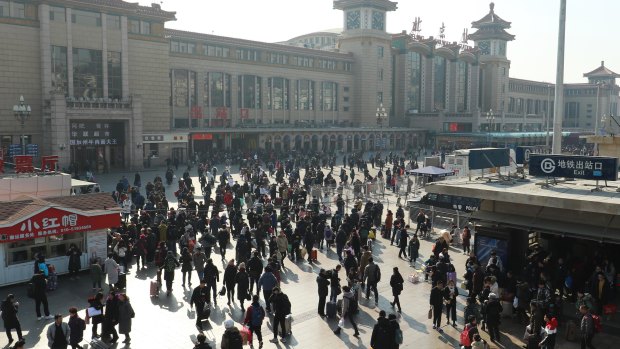 Passengers heading towards check-in at Beijing Railway Station.