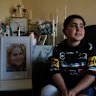 Sea World Helicopters crash victim Nicholas Tadros sits by a portrait of his late mother, Vanessa, at the family’s Glenmore Park home.