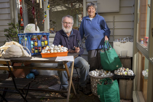 Bruce Lavender and Meredith Kefford with balls and a drone they have found at Merri Creek.