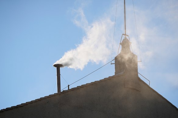 White smoke billows from the chimney of the Sistine Chapel during the conclave to elect a new pope.