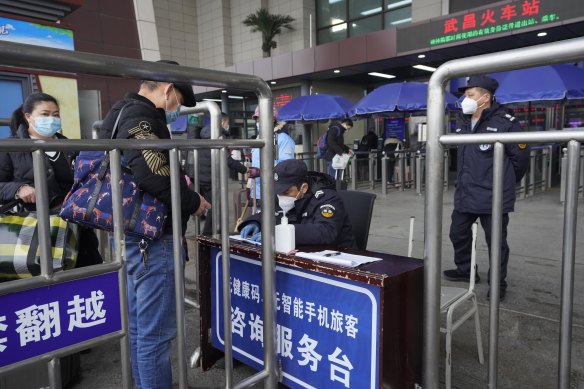 Travellers are screened before entering the Wuchang Railway Station in Wuhan.