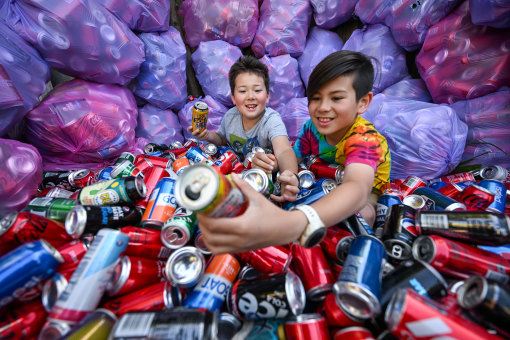 Return serve: Ashton Hanson, 10, (right) with brother Xavier are aiming to collect 10,000 cans.