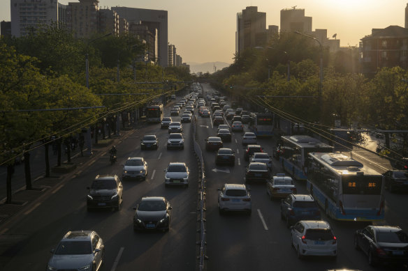 Traffic travel along a road in Beijing. The Chinese economy will grow by less than 2 per cent in 2020 as the anti-virus shutdowns combine with a collapse in global demand due to the pandemic, according to Bloomberg.