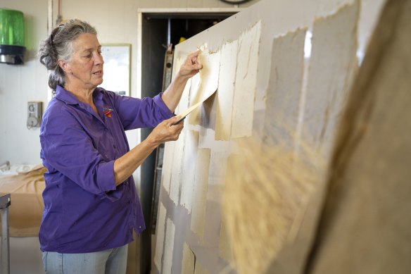 Lyndee Severin with Curtin Springs paper, made by handcutting grass to craft pieces individually.