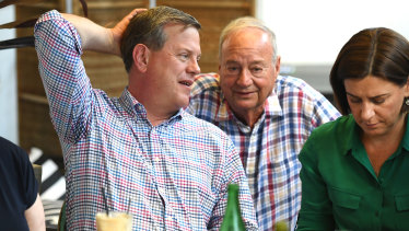 Opposition leader Tim Nicholls, flanked by his deputy Deb Frecklington, chats to his father Peter as he meets family and friends at a cafe in Brisbane on Sunday.