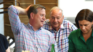 Opposition leader Tim Nicholls, flanked by his deputy Deb Frecklington, chats to his father Peter as he meets family and friends at a cafe the day after the ballot.