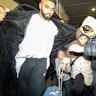 A woman believed to be Zahra Ahmad was escorted through the arrivals hall at Melbourne Airport by some male supporters, with a media scrum in hot pursuit.