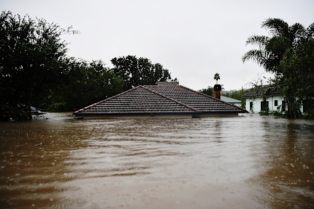 A house in the centre of Lismore is submerged to its roof during the town’s highest recorded flood on March 1, 2022.