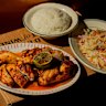 Wood-fired free-range chicken with burnt-chilli nuoc mam, papaya salad and steamed rice at Firebird in Prahran.