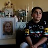 Sea World helicopter crach survivor Nicholas Tadros at home by the portrait of his late mother, Venessa. Nicholas is a Panthers fan and has been invited by the NRL to watch Sunday’s grand final at Accor Stadium.