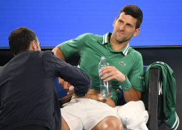 Djokovic receives treatment during his third round match against Taylor Fritz at the Australian Open on Friday night.