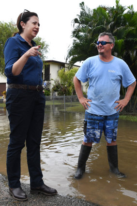 Ms Palaszczuk meets Nigel and Belinda Strong outside their flood-affected house.