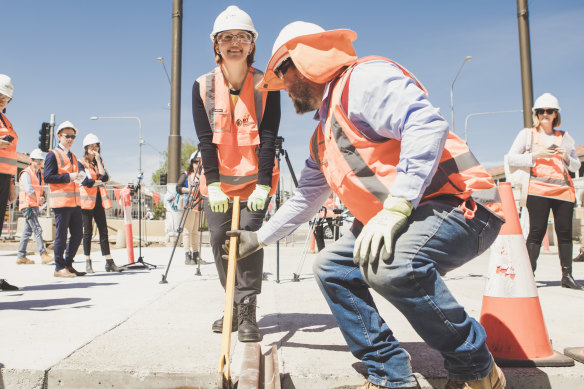 Minister for Transport Meegan Fitzharris helping install the last section of rail along the Gungahlin to the city light rail corridor last month.
